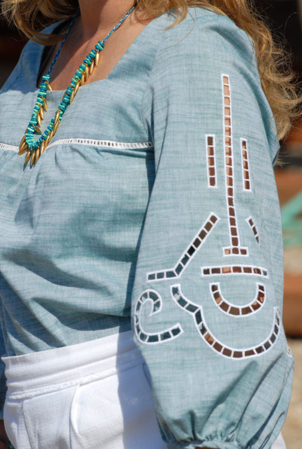 Close up, wearing Ancient Kallos cut out embroidered blouse and Mina's handmade necklace