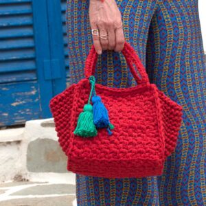 Holding red croshet bag