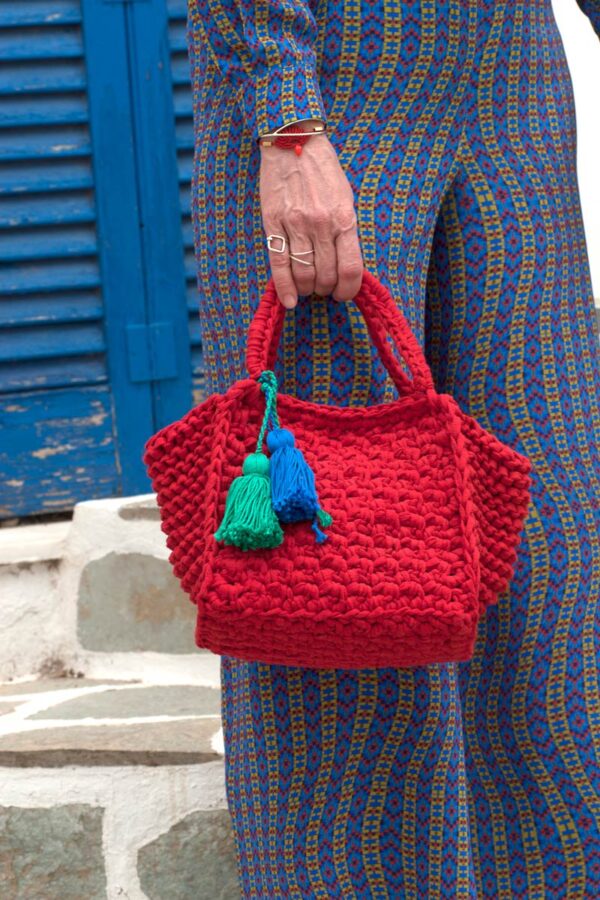 Holding red croshet bag