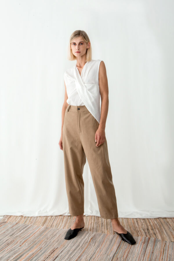 Model wearing high waisted sand pants