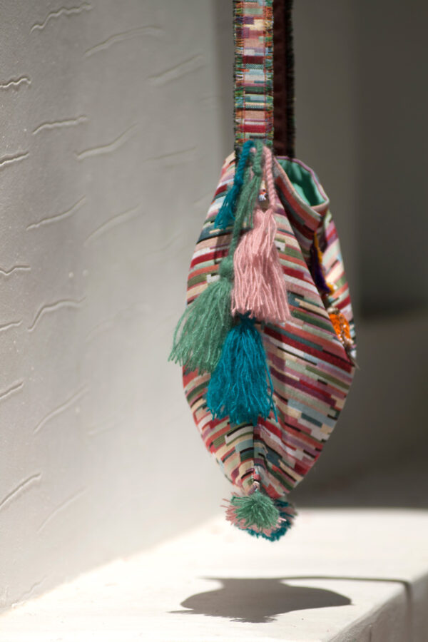 Mina's handmade woven bag with tassels