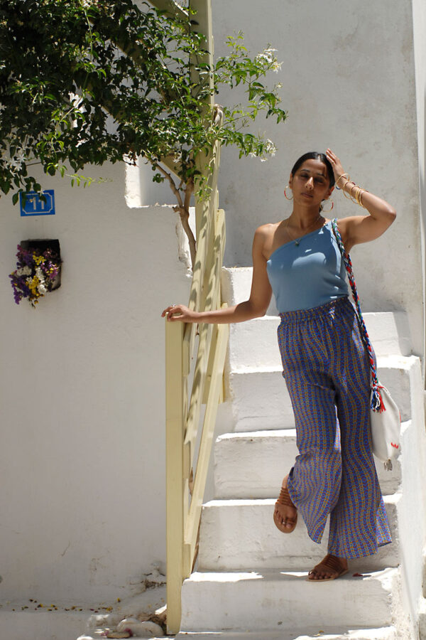 Model wearing light blue one shoulder top