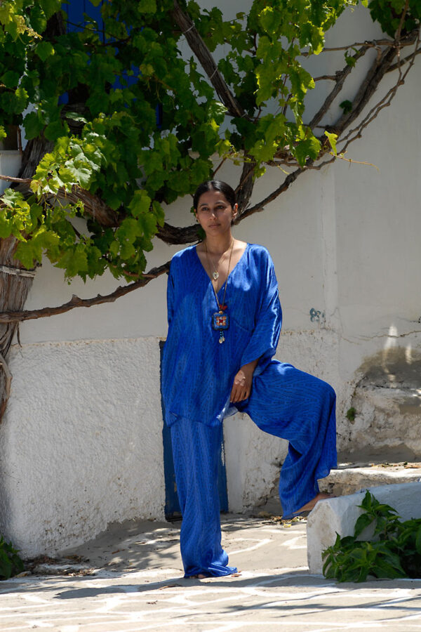 Model wearing blue wrap long blouse