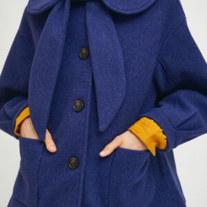 Close up photo, model wearing blue coat