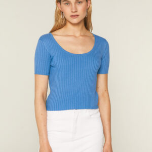 Model wears blue knit top