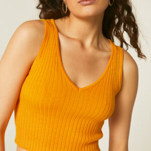 Model wears yellow strech ribbed top