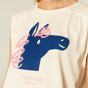 Close up photo, model wears white cotton horse print top