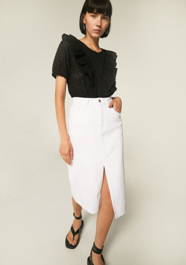 Model wears, denim skirt with front slit