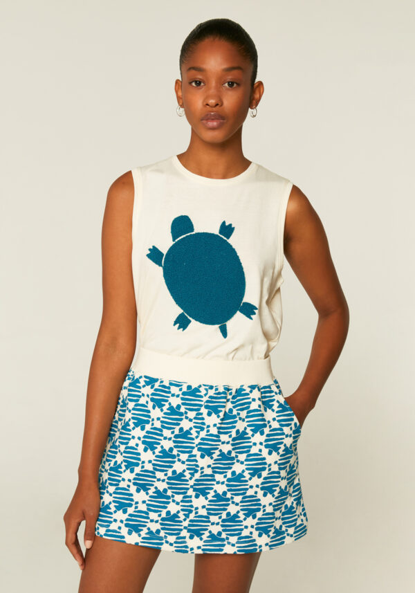 Model is wearing turtle print top