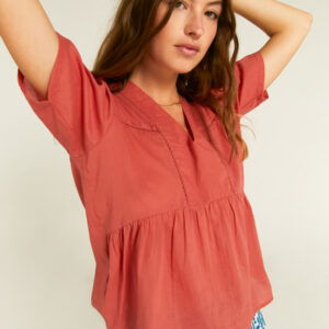 Close up photo, model is wearing brown cotton voile top