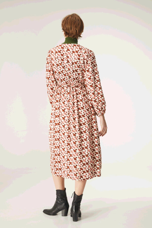 Back photo model wears print dress with elasticated waist