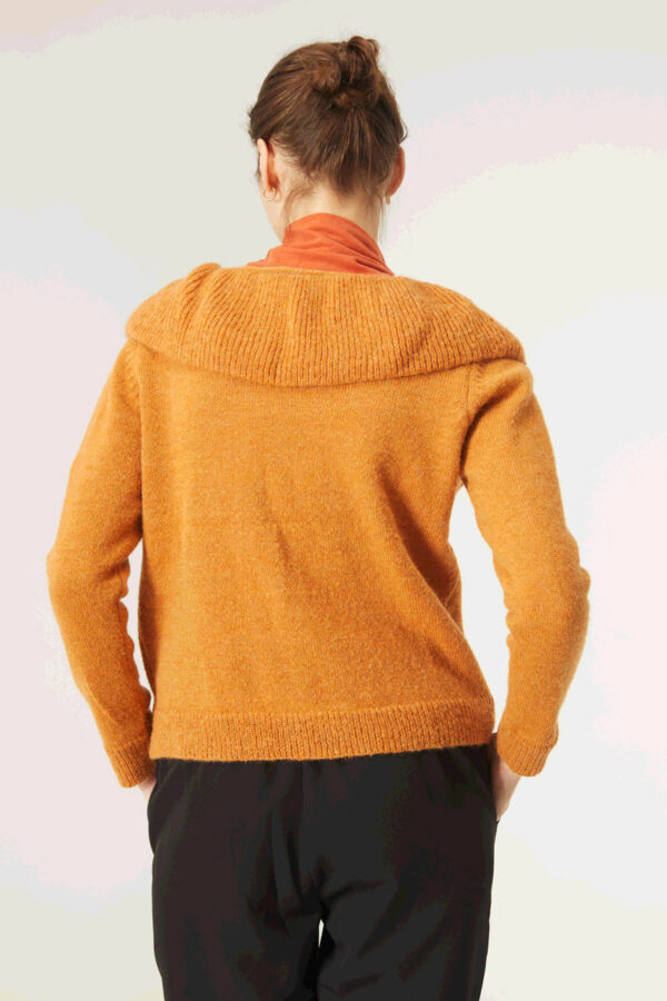 Back photo, model wears short mustard sweater
