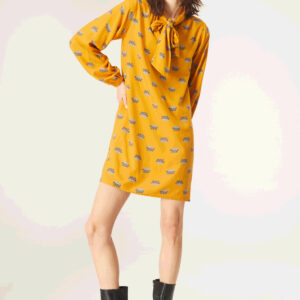 Model wears mustard floral print dress