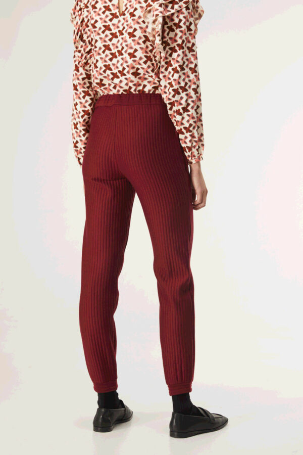 Back photo, model wears burgundy pants