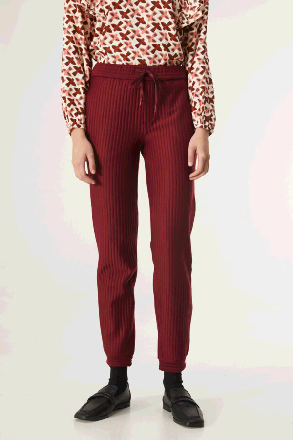 Close up photo, model wears burgundy quilted pants