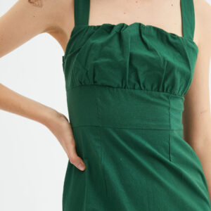 Close up photo model wears green cotton dress