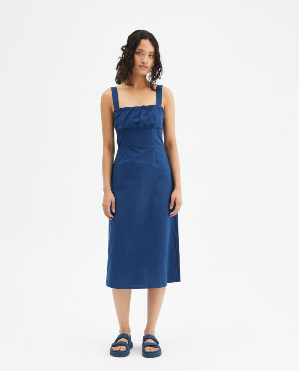 Model wears blue midi dress