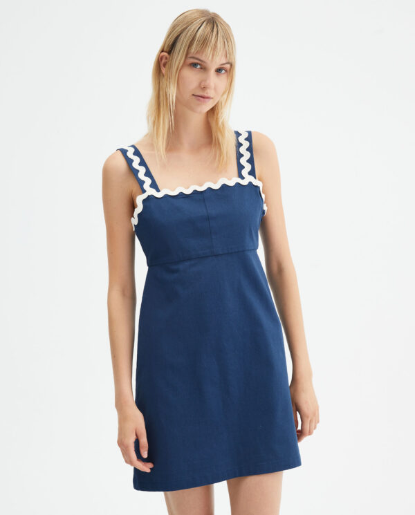 Model wears blue cotton mini dress