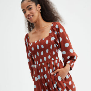Model wears polka dot dress