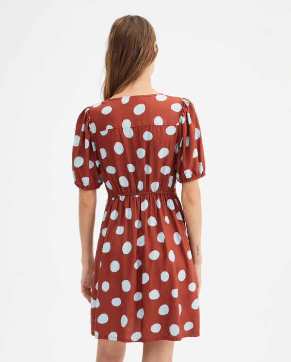 Back photo, model wears brown polka dot short dress