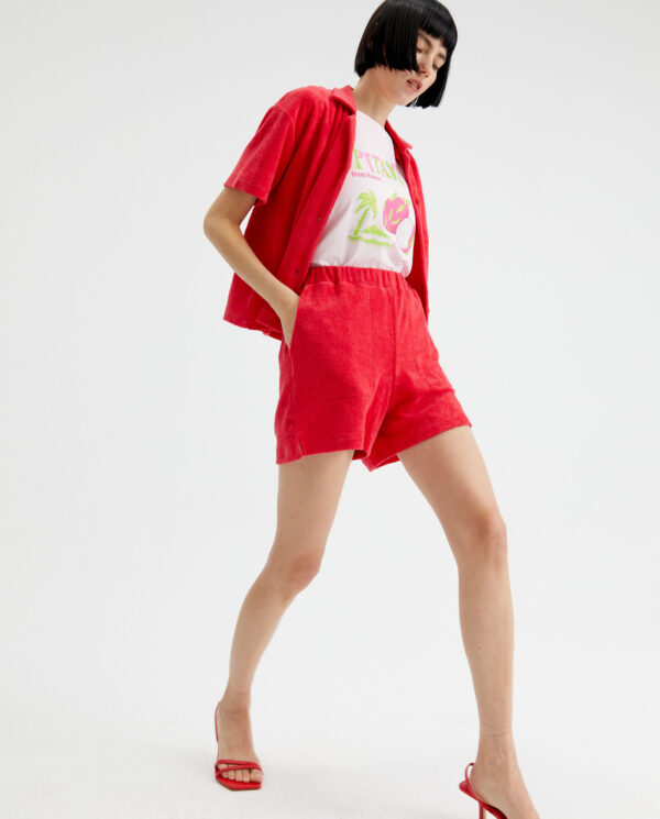 Model wears fucsia towelling shorts