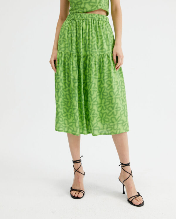 Close up photo model wears green midi skirt