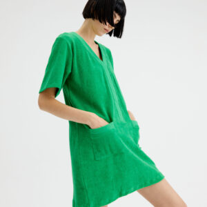 Model wears green mini dress in towelling fabric