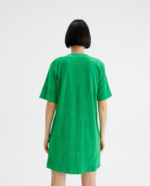 Back photo model wears green cotton dress