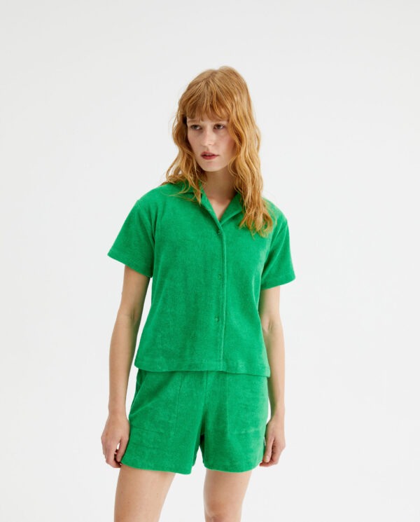 Model wears green towelling short shirt