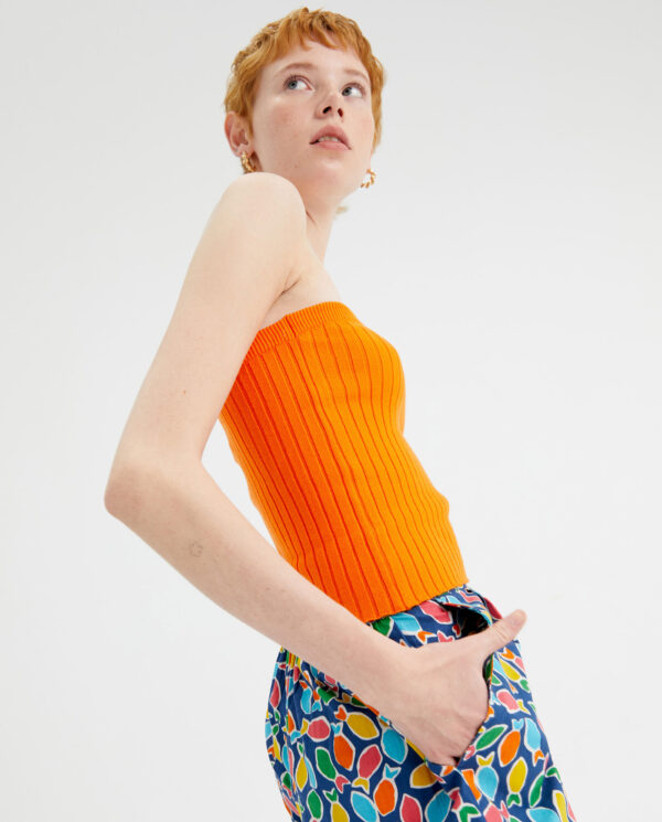Profile photo model wears orange knit top