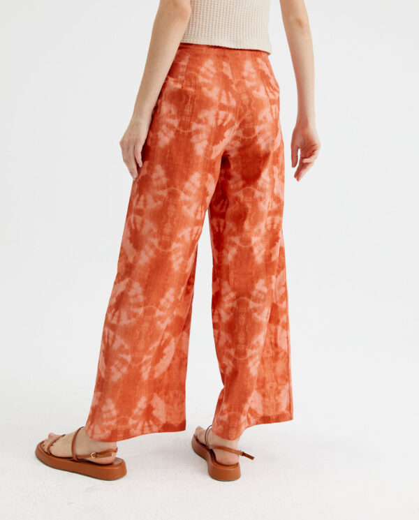 Back photo model wears peach tie dye pants