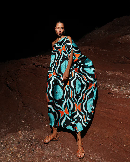 Model wears asymetrical printed dress